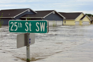 Ten feet of water flood nearly 20 percent of the neighborhood throughout the city of Minot, N.D., leaving more than 4,000 homes inundated by flooding, June 25. With the Souris River expected to crest, city official scramble to implement a recovery strategy hoping to endure the high water preventing the loss of thousands of homes already damaged by flooding. At eight feet above major flood stage, the water appears to be leveling off.