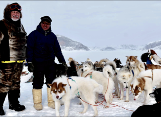 John Englander with Inuit guide and sled dogs.